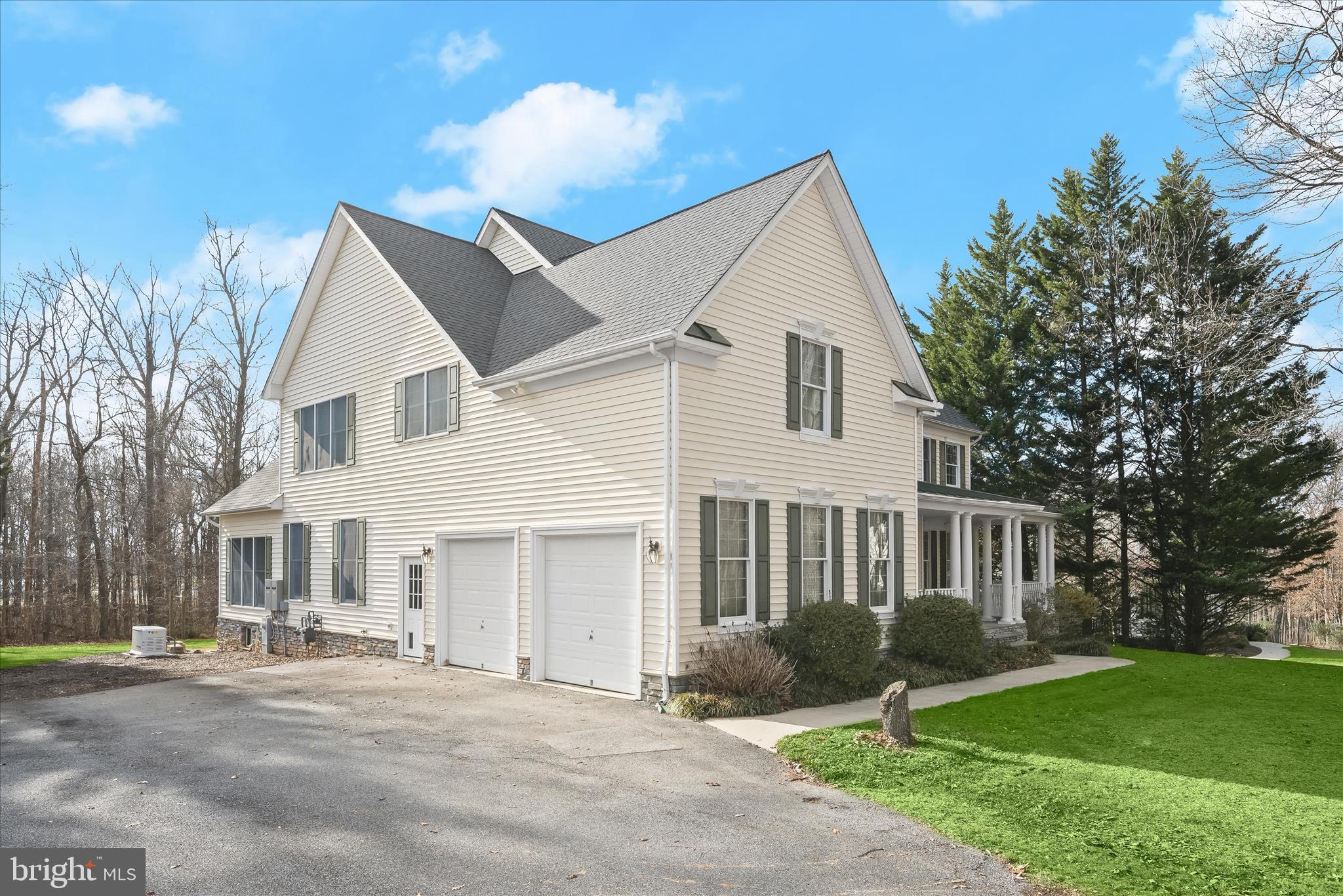 15286 Ridge Hunt Drive Woodbine, MD 21797 - Photo 87 of 100 a front view of a house with a yard and garage