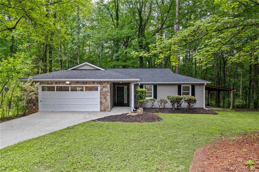 1216 Monticello Drive Villa Rica, GA 30180 - Photo 1 of 1 a front view of a house with garden