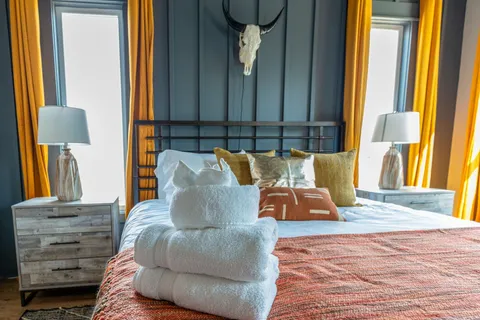 a bedroom with a bed and a television
