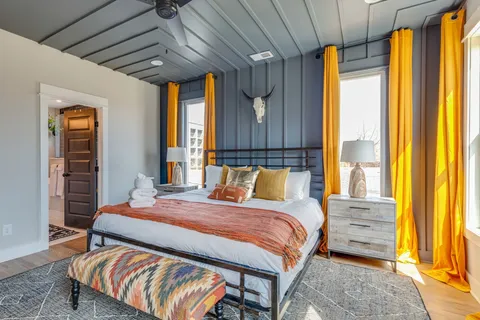 a bedroom with a bed and wooden floor