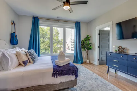 a living room with furniture ceiling fan and a window