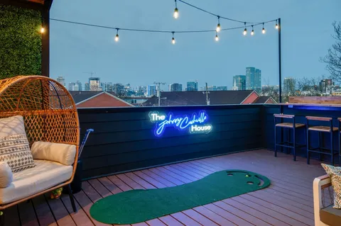 a backyard of a house with barbeque oven table and chairs