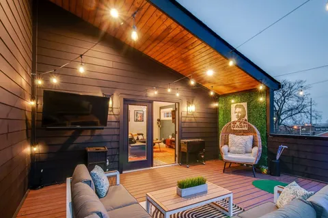 a bed sitting in a room next to a lamp with wooden floor