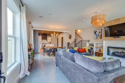 a living room with fireplace furniture and a flat screen tv