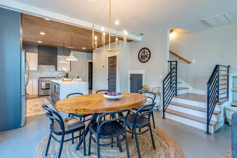 a view of a dining room with furniture and a chandelier