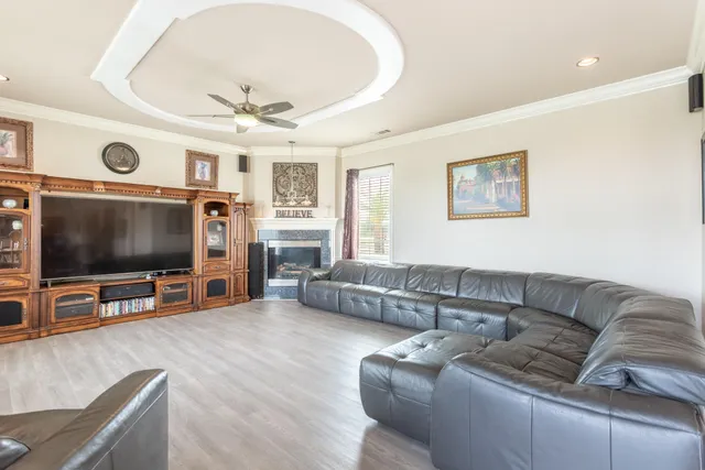 a living room with furniture floor to ceiling window and potted plant