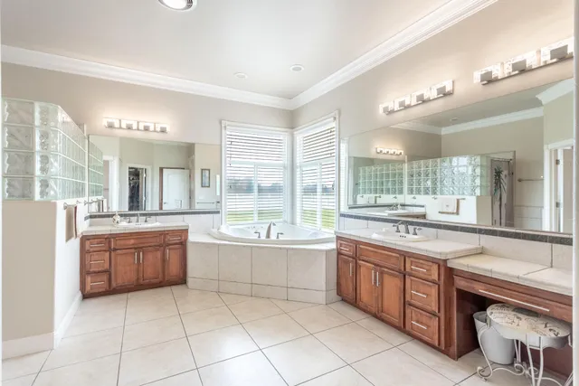 a large bathroom with a tub a sink a mirror and a shower