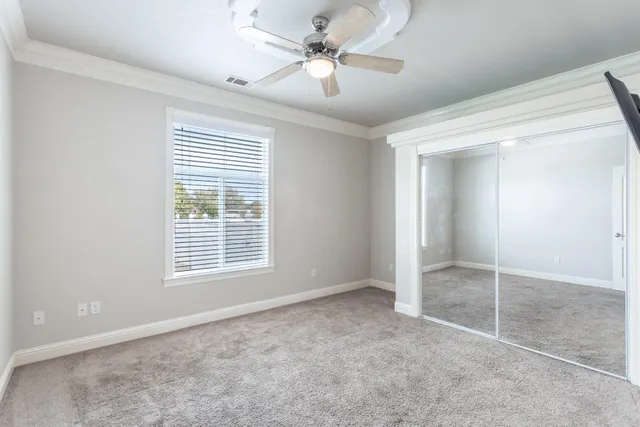 a living room with furniture and kitchen