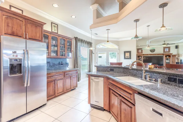 a kitchen with stainless steel appliances granite countertop a stove a sink and a microwave
