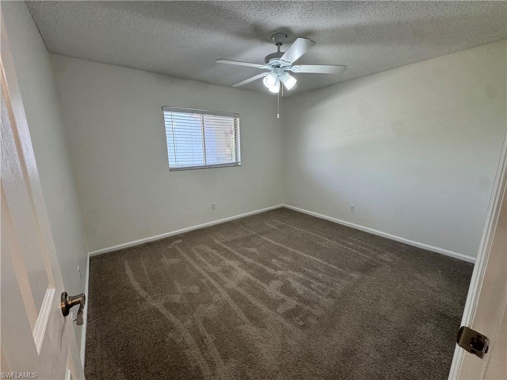 5667 Rattlesnake Hamm Road North, Unit B301 Naples, FL 34113 - Photo 13 of 17 an empty room with a chandelier fan
