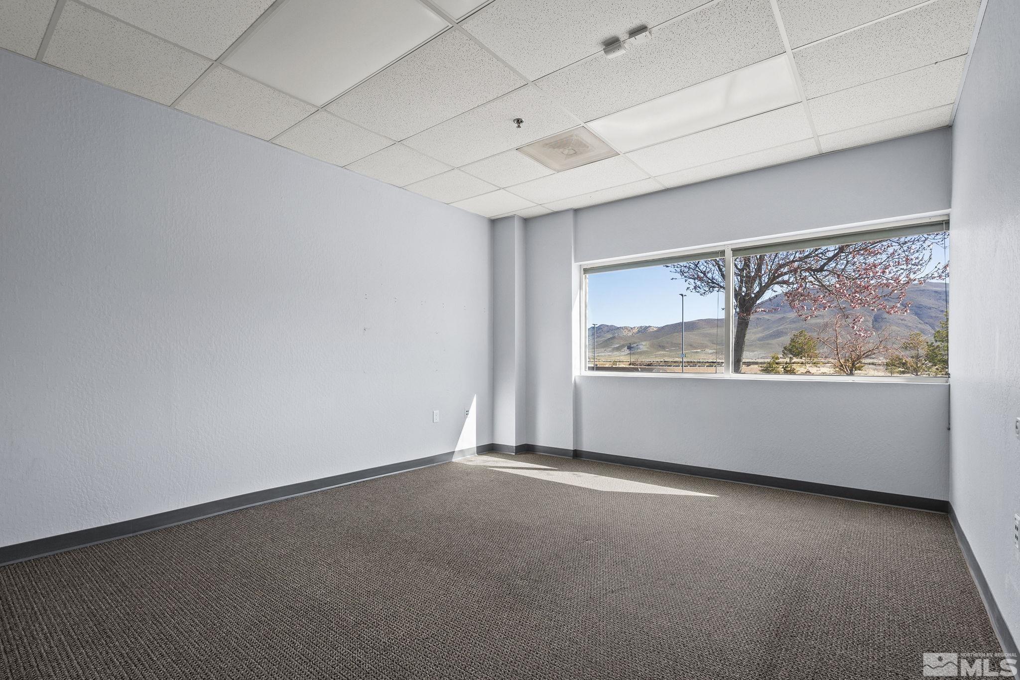1190 Trademark Drive, Unit 108 108 Reno, NV 89521 - Photo 20 of 20 an empty room with wooden floor and windows