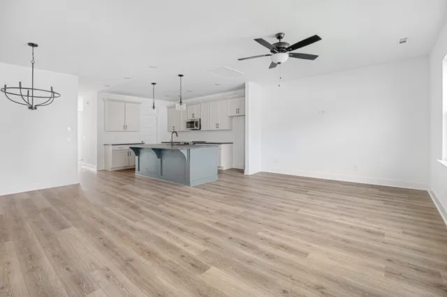 a view of a kitchen with a sink and a refrigerator