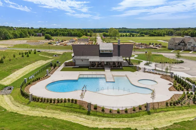 an aerial view of a house with a big yard