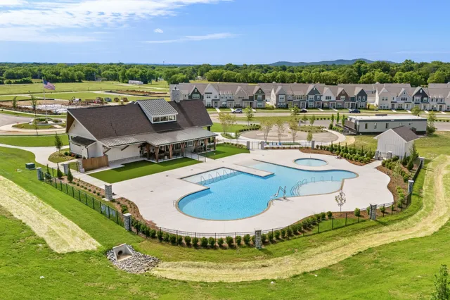 a view of a house with yard and swimming pool