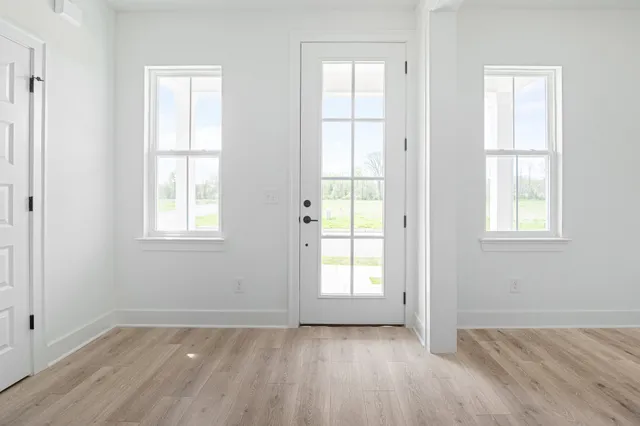 an empty room with windows and closet