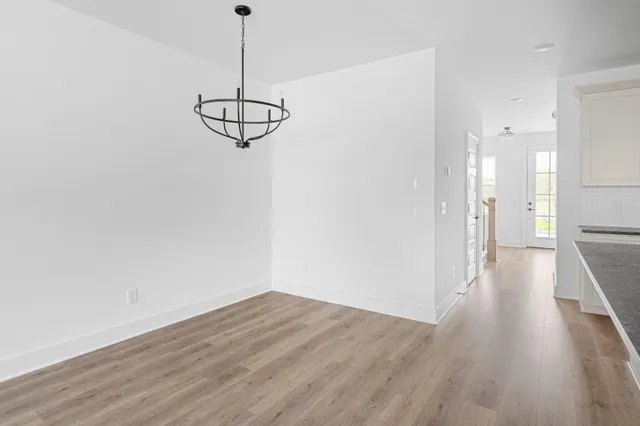 a view of a room with wooden floor and a window