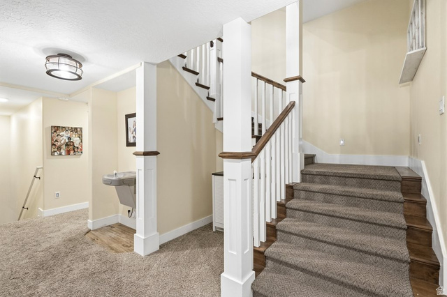 672 Perry Hollow Drive Mapleton, UT 84664 - Photo 40 of 106 Carpeted staircase with wood-finish risers and balusters