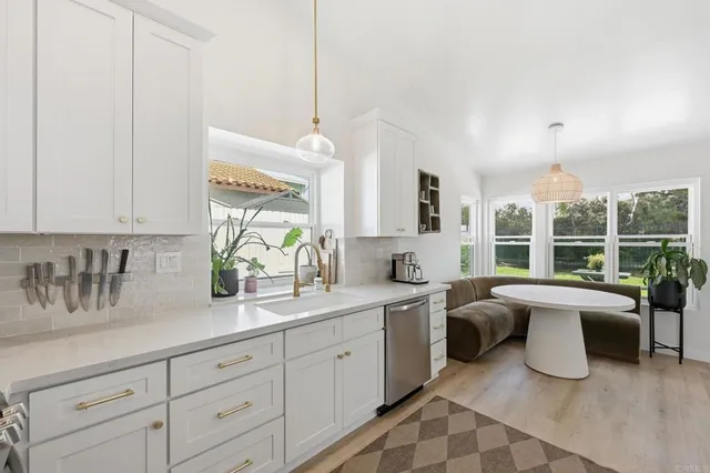 a spacious en suite bathroom with double sink and large window