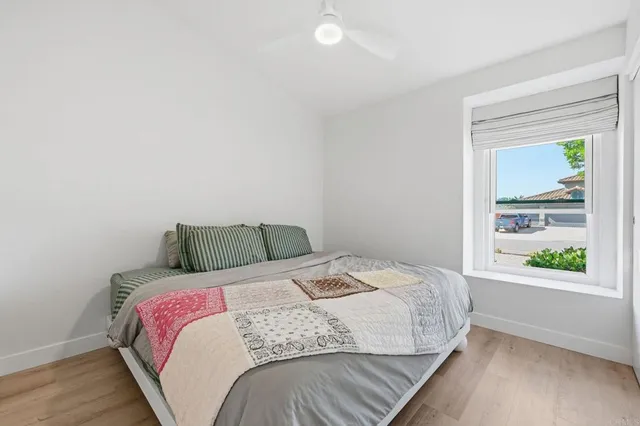 a bed sitting in a bedroom next to a window
