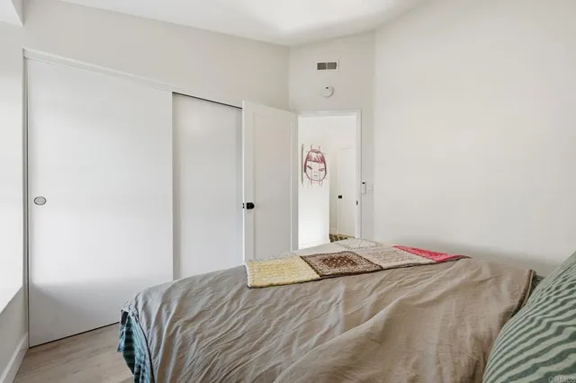 a bedroom with a bed and a closet