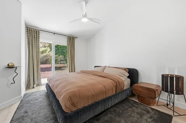 a large bed sitting in a bedroom next to a window