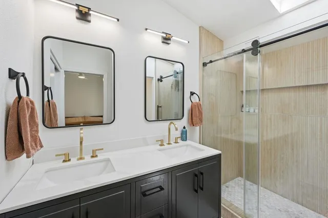 a bathroom with a double vanity sink mirror and double