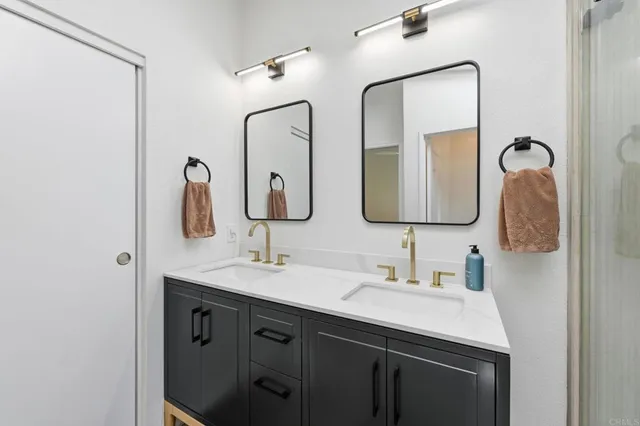 a bathroom with a double vanity sink and a mirror