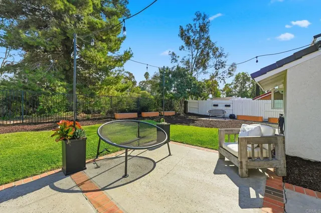 a view of a chairs and table in the backyard