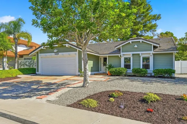 a front view of a house with a yard and a garage