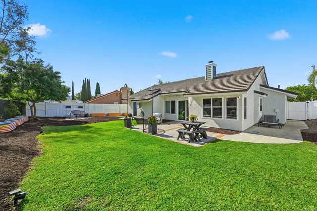 a front view of a house with garden and patio