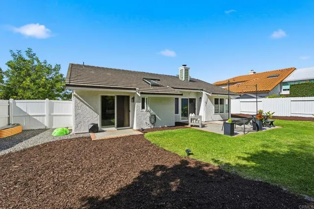 a front view of a house with a garden and patio
