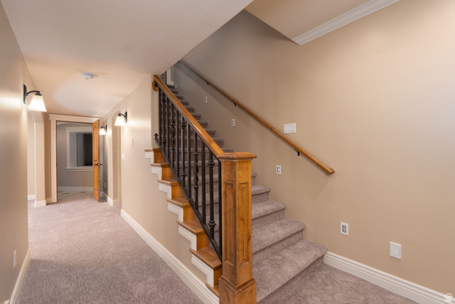 687 South 2080th Street East Springville, UT 84663 - Photo 27 of 149 Staircase featuring wood newel post and handrail, wrought iron balusters, and carpeted treads