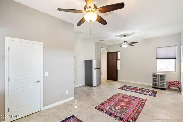 a bedroom with a bed and a chandelier fan