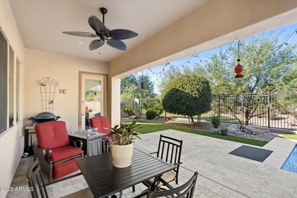 a view of a swimming pool with outdoor seating