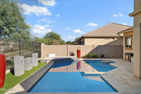 a view of a house with swimming pool and sitting area