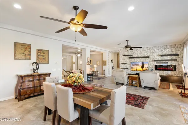 a living room with furniture kitchen view and a window