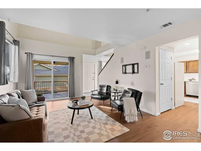 a living room with furniture a rug and a fireplace
