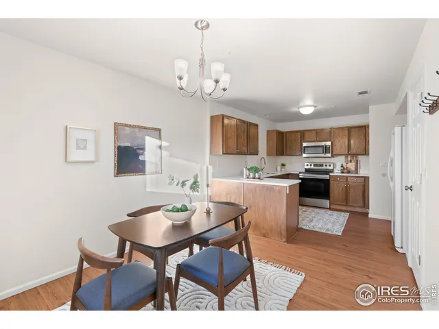a view of a dining room with furniture and a chandelier