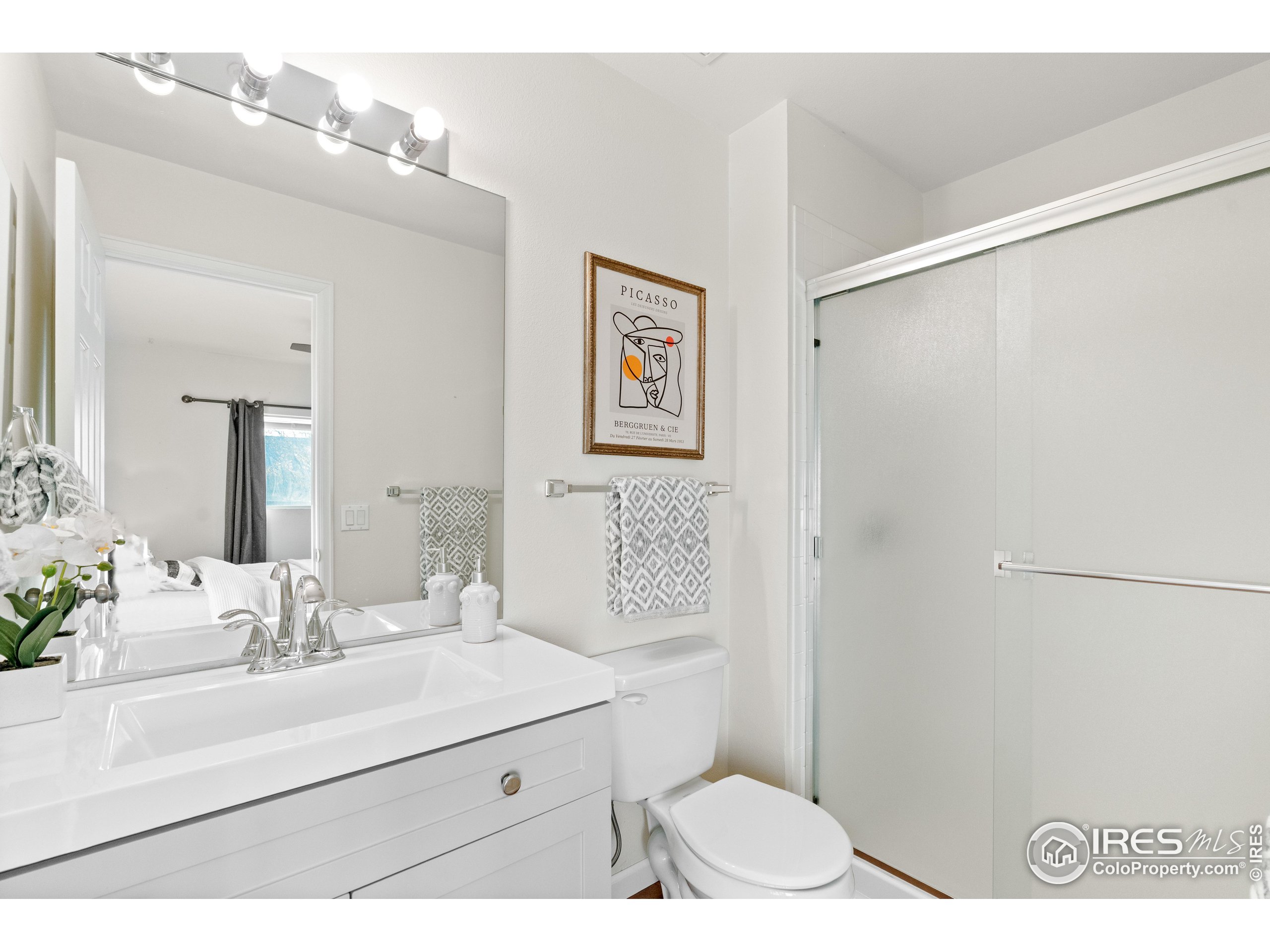 2900 Purcell Street, Unit O4 Brighton, CO 80601 - Photo 21 of 28 a bathroom with a sink mirror vanity and toilet