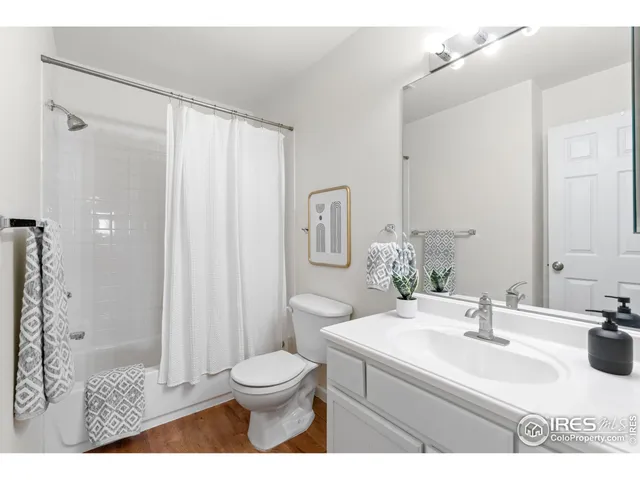 a utility room with dryer washer and a view of living area