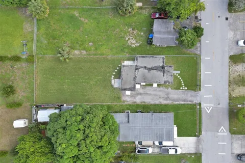 an aerial view of a house with a yard