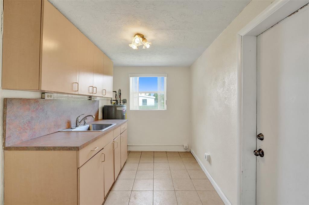 2055 Northwest 8th Street Pompano Beach, FL 33069 - Photo 7 of 20 a kitchen with a sink and cabinets