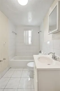 a bathroom with a sink a toilet and a bathtub