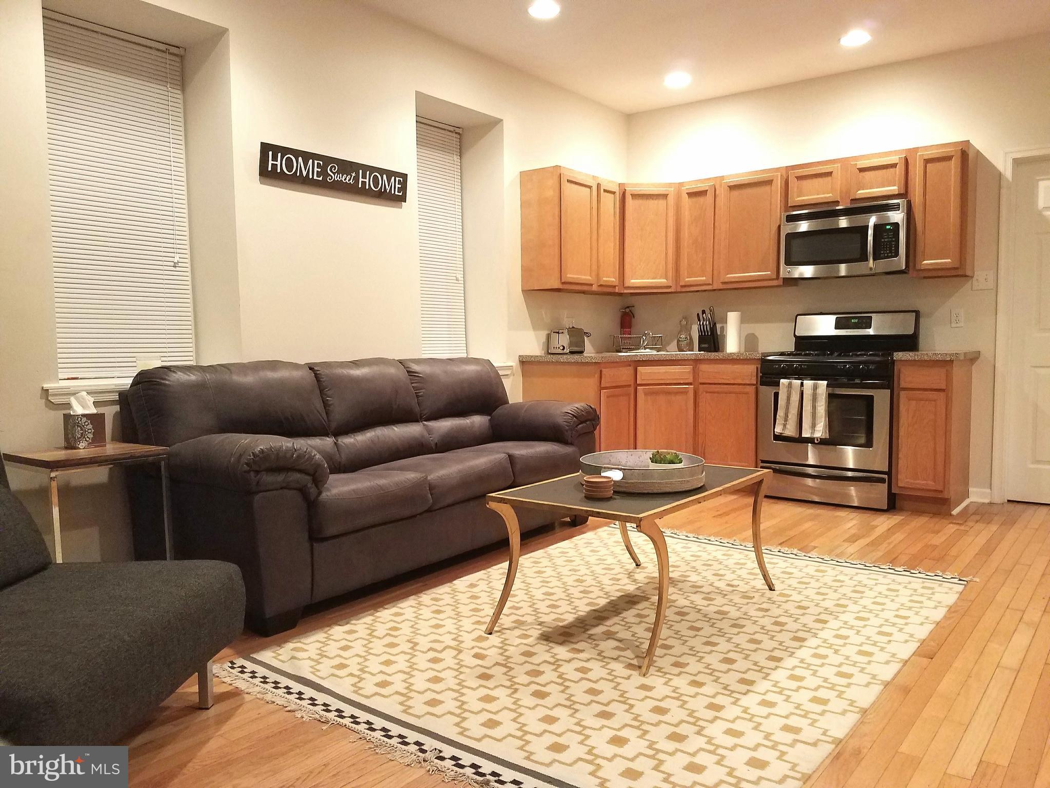 1951 South 4th Street Philadelphia, PA 19148 - Photo 1 of 3 a living room with stainless steel appliances furniture and a kitchen view