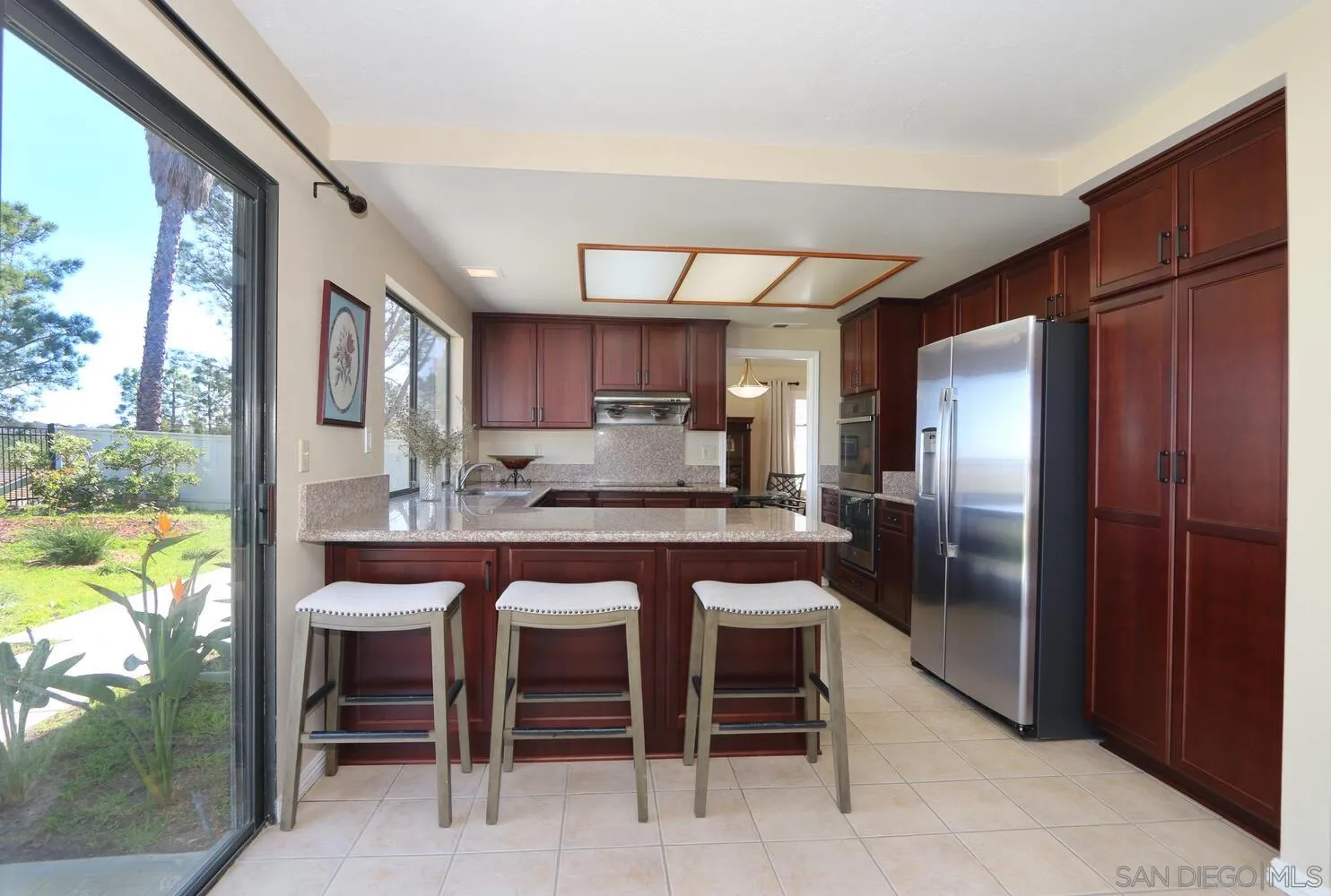 13375 Roxton Circle San Diego, CA 92130 - Photo 12 of 29 a kitchen with stainless steel appliances granite countertop a refrigerator and a sink
