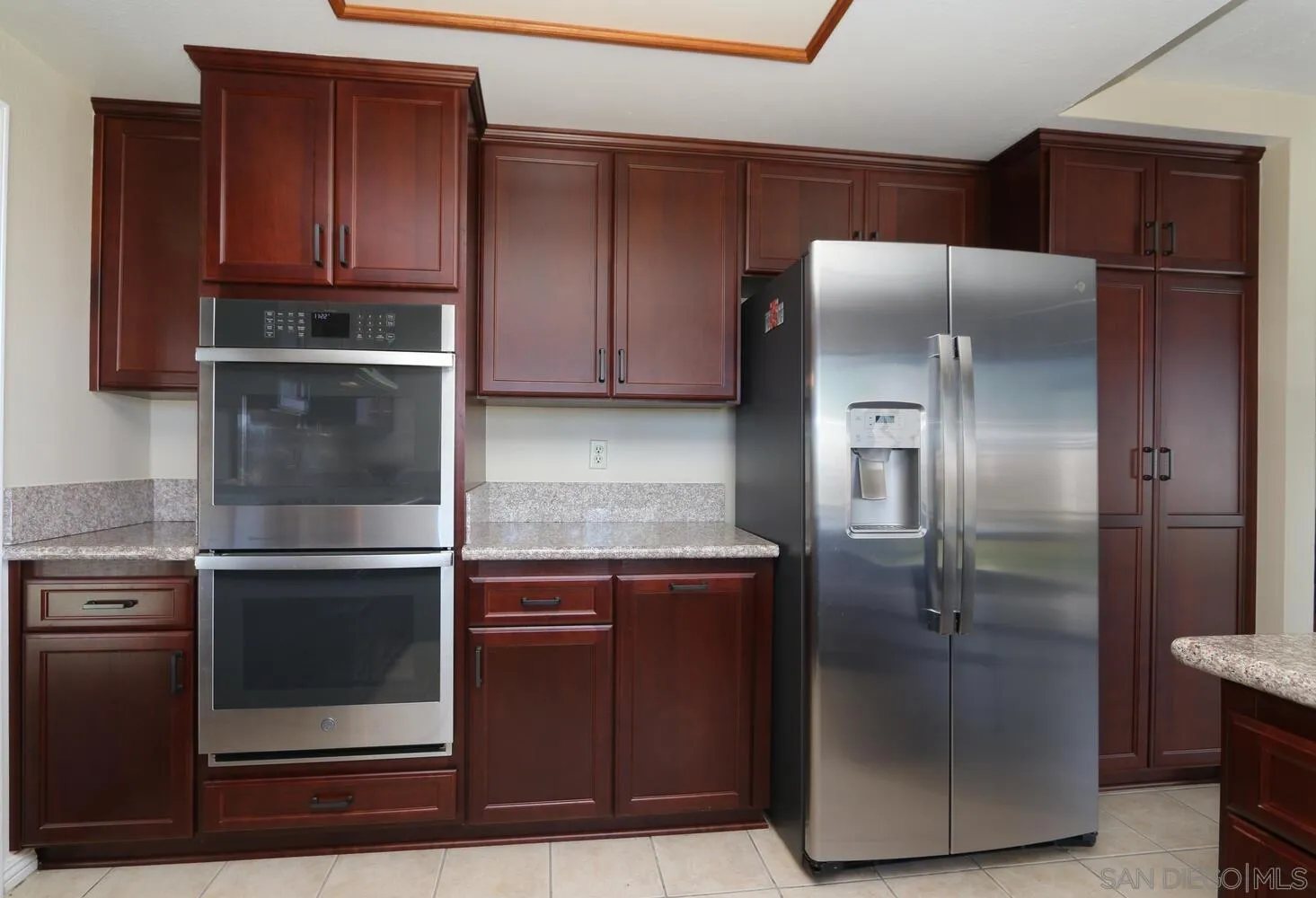 13375 Roxton Circle San Diego, CA 92130 - Photo 13 of 29 a kitchen with granite countertop a refrigerator and a stove