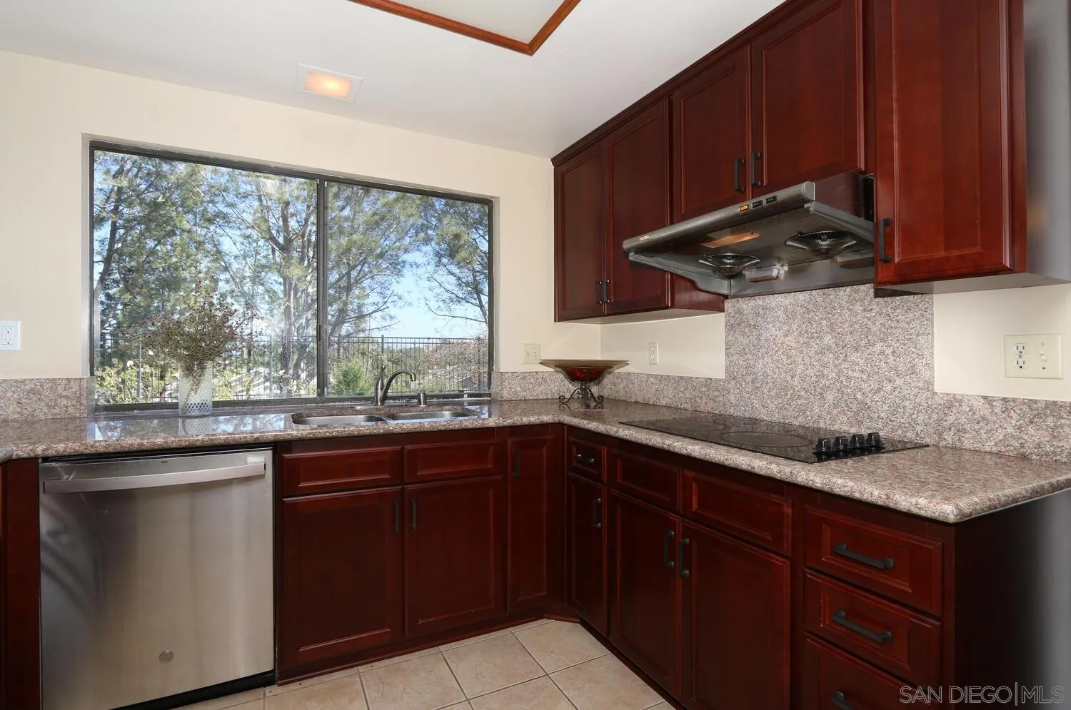 13375 Roxton Circle San Diego, CA 92130 - Photo 14 of 29 a kitchen with a sink and wooden cabinets