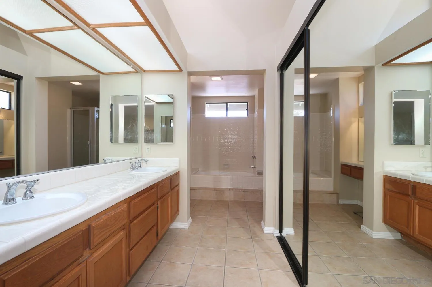 13375 Roxton Circle San Diego, CA 92130 - Photo 17 of 29 a spacious bathroom with a double vanity sink mirror and shower