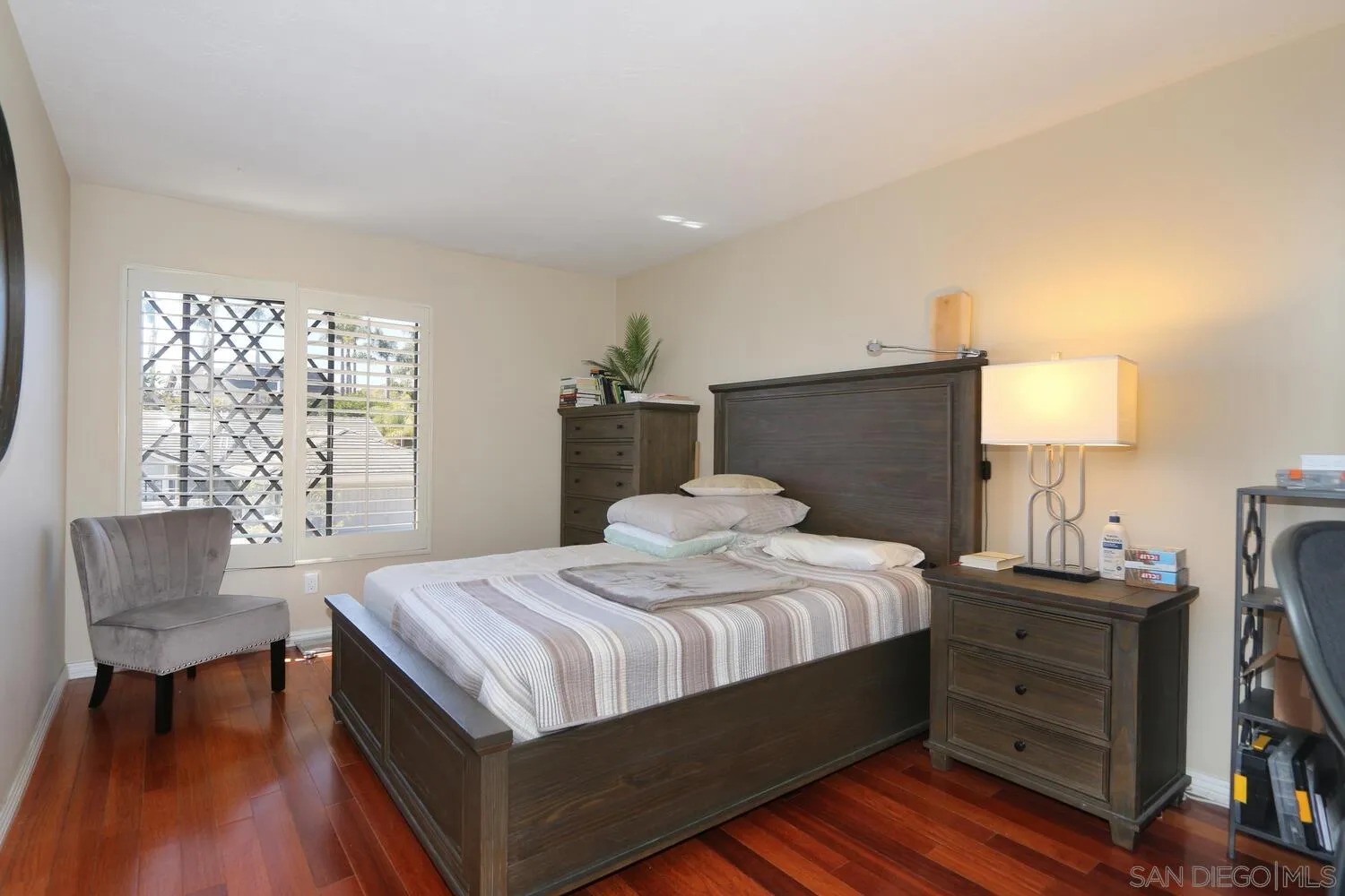 13375 Roxton Circle San Diego, CA 92130 - Photo 19 of 29 a bedroom with a bed and a chair