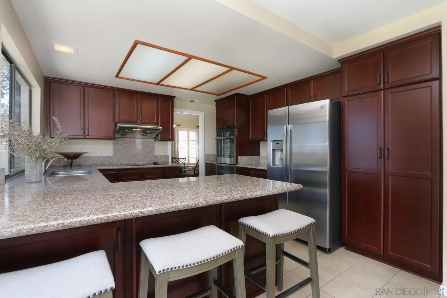 13375 Roxton Circle San Diego, CA 92130 - Photo 6 of 29 a kitchen with stainless steel appliances granite countertop a sink refrigerator and microwave